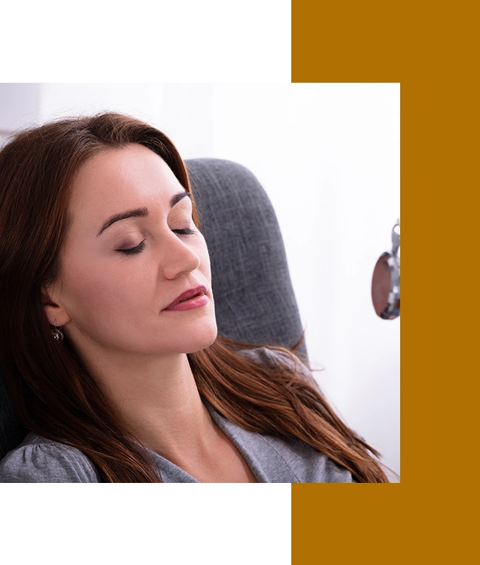 A person with closed eyes rests on a chair in a relaxed pose, embracing the serenity of emotional wellbeing.