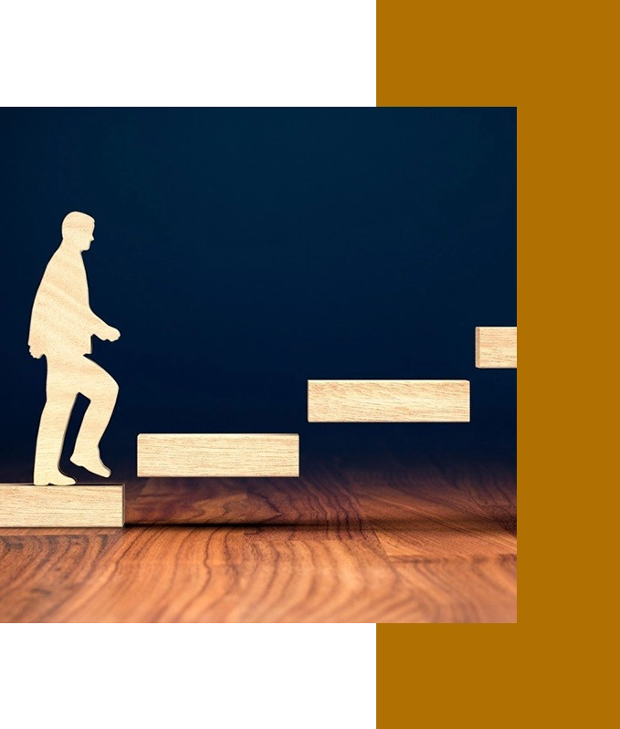 Silhouette of a person climbing wooden block stairs on a wooden surface against a dark background, symbolizing the journey of hypnosis for personal growth.