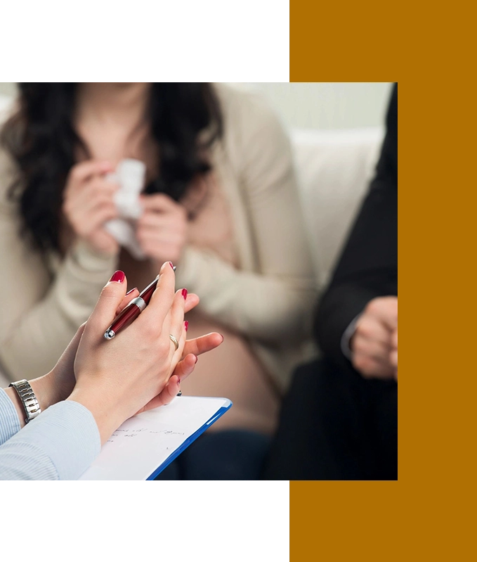 Two individuals sit with a therapist holding a pen and clipboard, suggesting a counseling session. In this serene setting, the conversation subtly shifts towards the potential benefits of hypnosis services in Hartsville, offering new pathways to personal growth and healing.